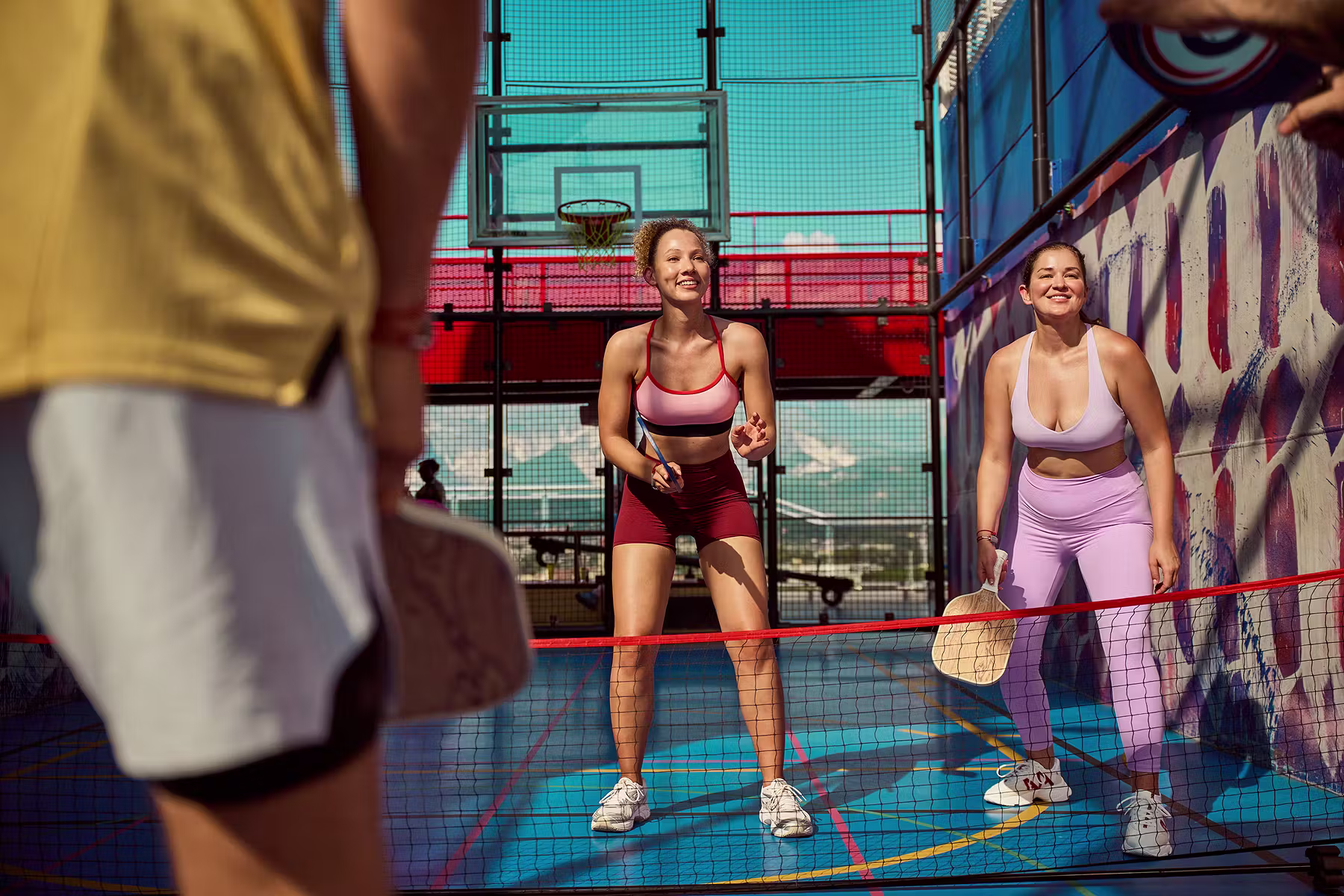 Guests playing pickleball on the sports court