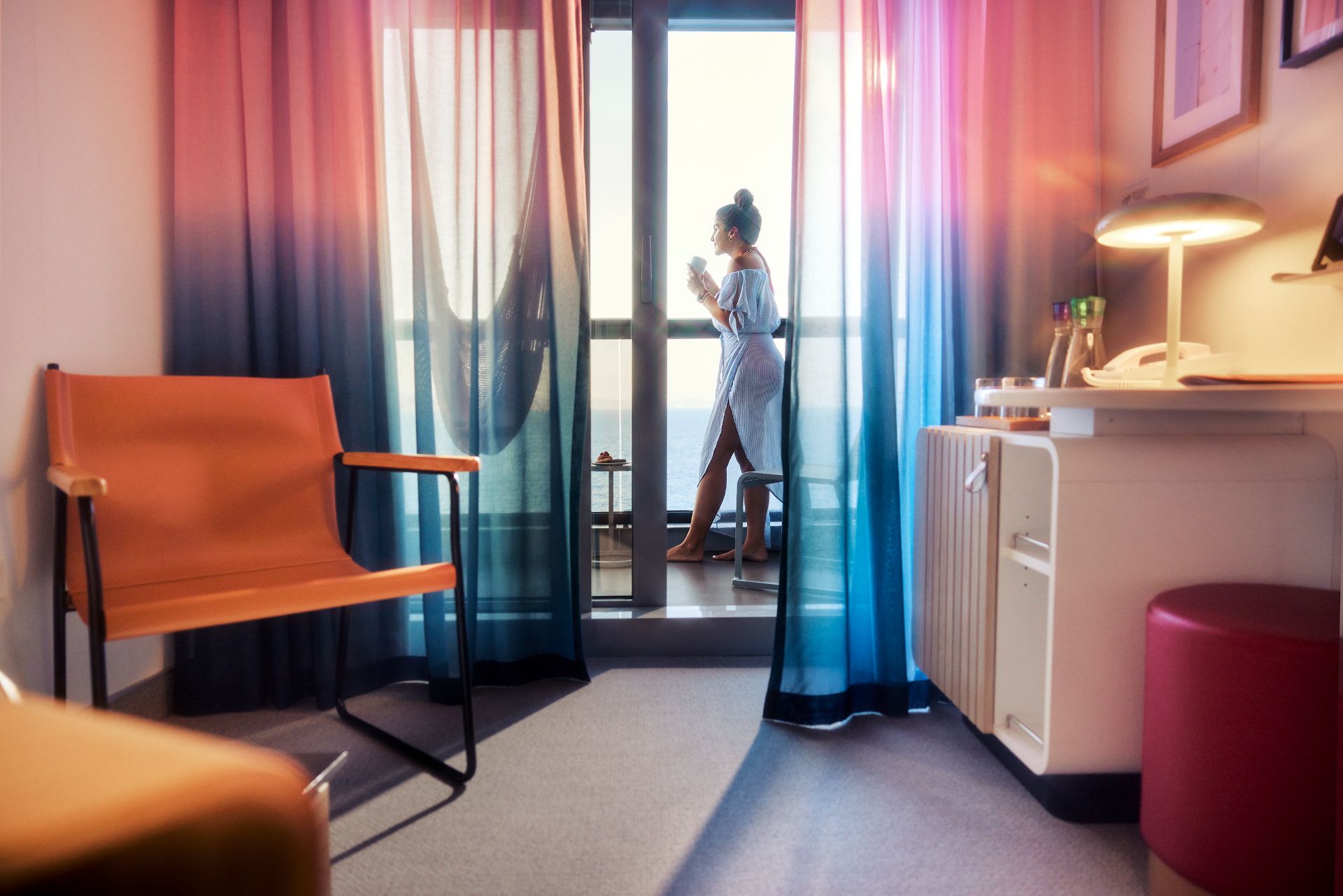 Guest enjoying ocean views from her cabin balcony